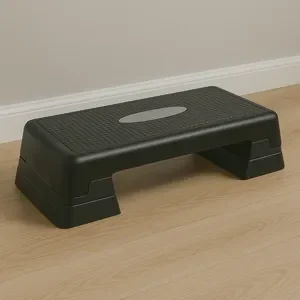 A_photograph_presents_a_black_aerobic_step_platfor